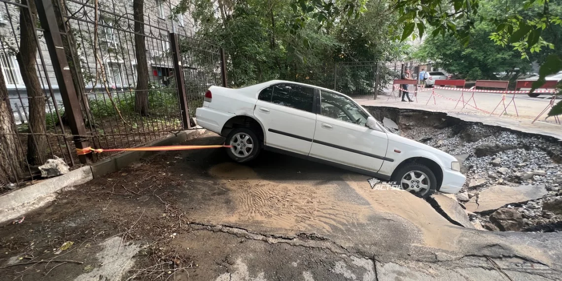Легковушка почти ушла под землю на Вокзальной магистрали — её прицепили к забору за буксировочный трос